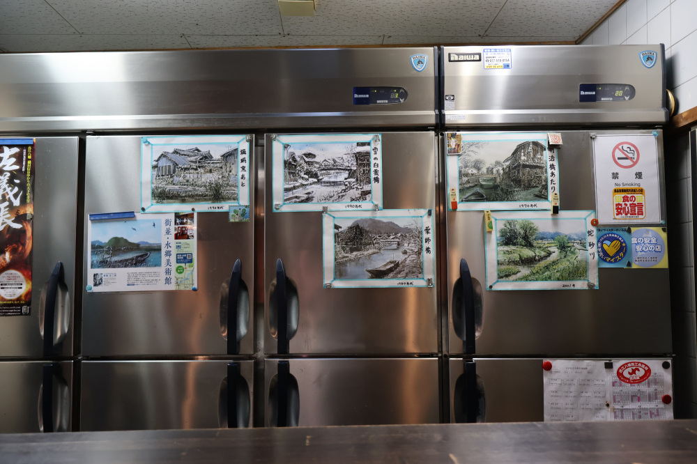 カウンターから見える冷蔵庫には近江八幡の歴史写真